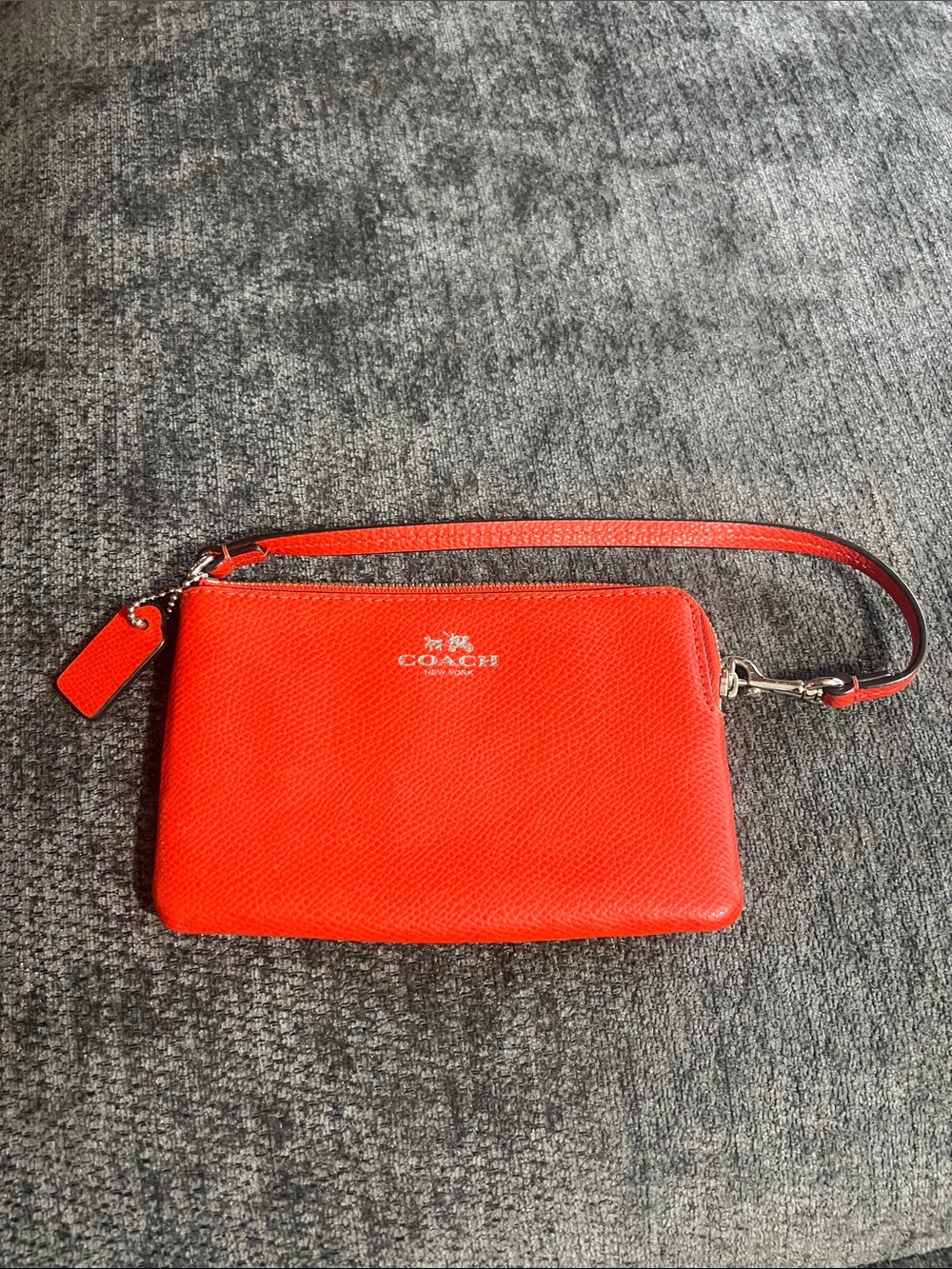Coach orange/red Pebbled Leather wristlet.